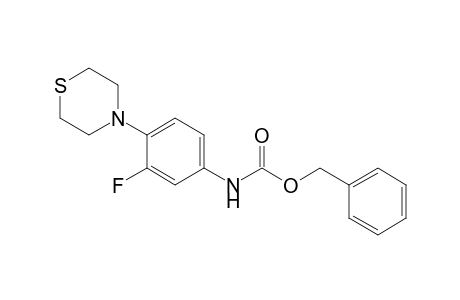 (phenylmethyl) N-(3-fluoranyl-4-thiomorpholin-4-yl-phenyl)carbamate