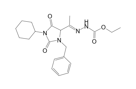 Ethyl 2-[1-(3-benzyl-1-cyclohexyl-2,5-dioxoimidazolidin-4-yl)ethylidene]hydrazinecarboxylate