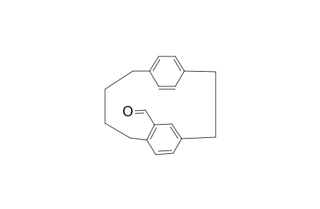 Tricyclo[10.2.2.2*4,7*]octadeca-1(15),4,6,12(16),13,17-hexaene-6-carbaldehyde