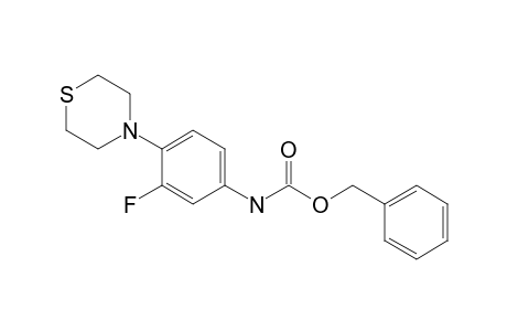 (phenylmethyl) N-(3-fluoranyl-4-thiomorpholin-4-yl-phenyl)carbamate